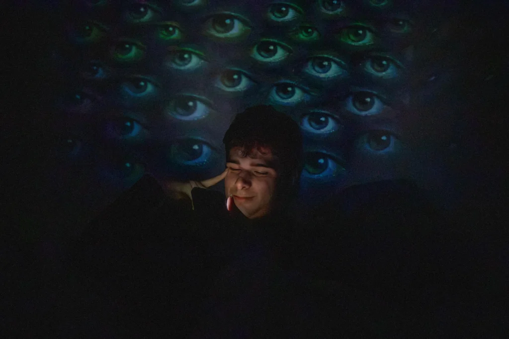 Fotografie Sympatickýho Sama, za ním na projekci oči